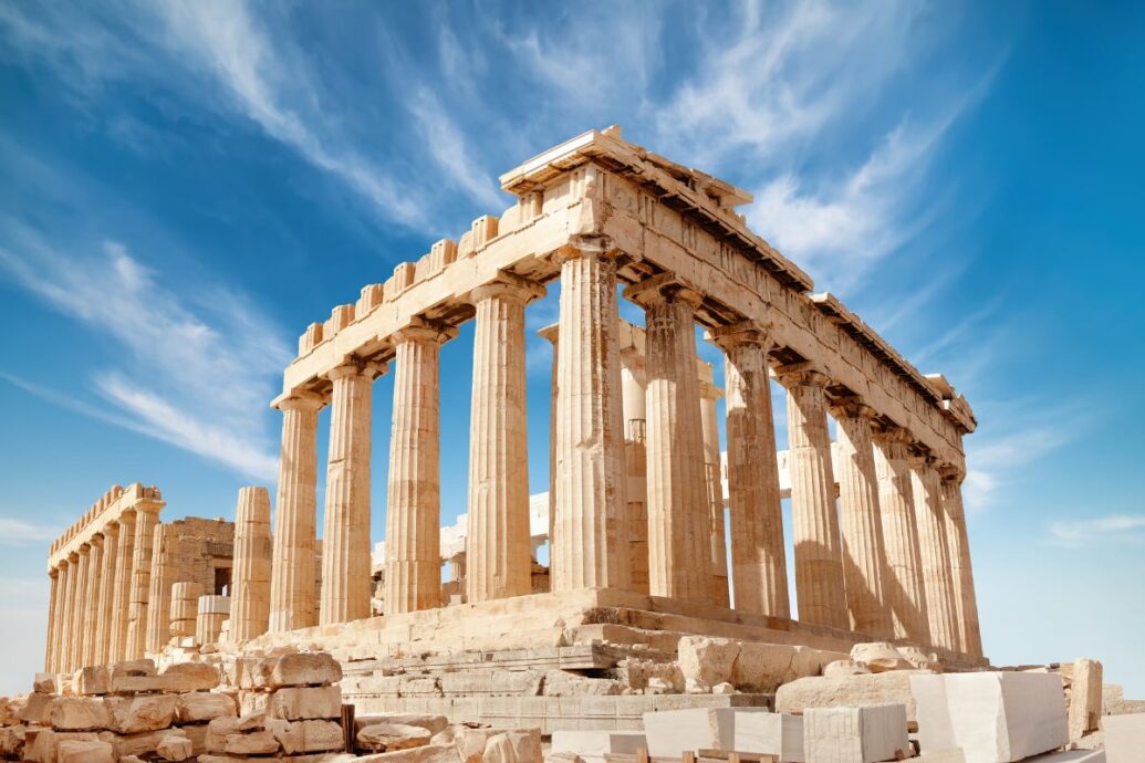 A majestic view of the Acropolis, showcasing the Parthenon with its ancient columns set against a vibrant blue sky.