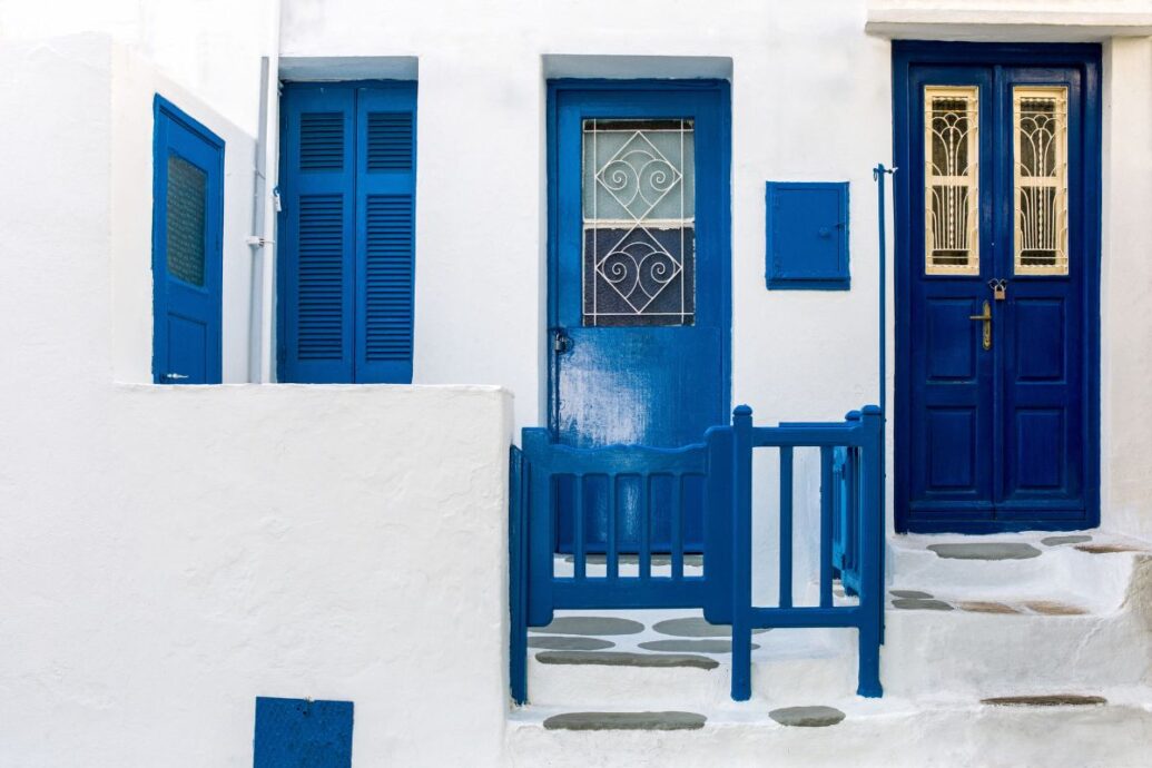 A charming doorway in Mykonos, featuring traditional blue doors and whitewashed walls._Mykonos Greece Vacation