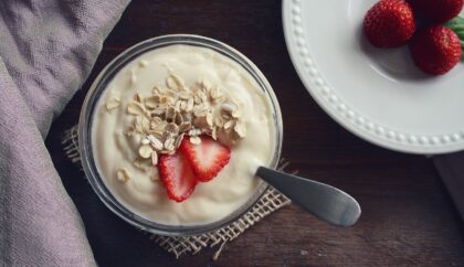 a bowl of greek yogurt with oats and strawberries